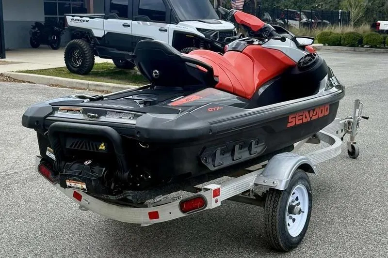 Slide: The Image of 2022 Sea-Doo GTI SE 130 jet ski on trailer, parked outdoors. - 7