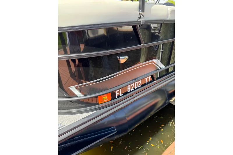 Slide: The Image of 2023 Starcraft EXS 3 Q boat with Florida registration, docked on water. - 11