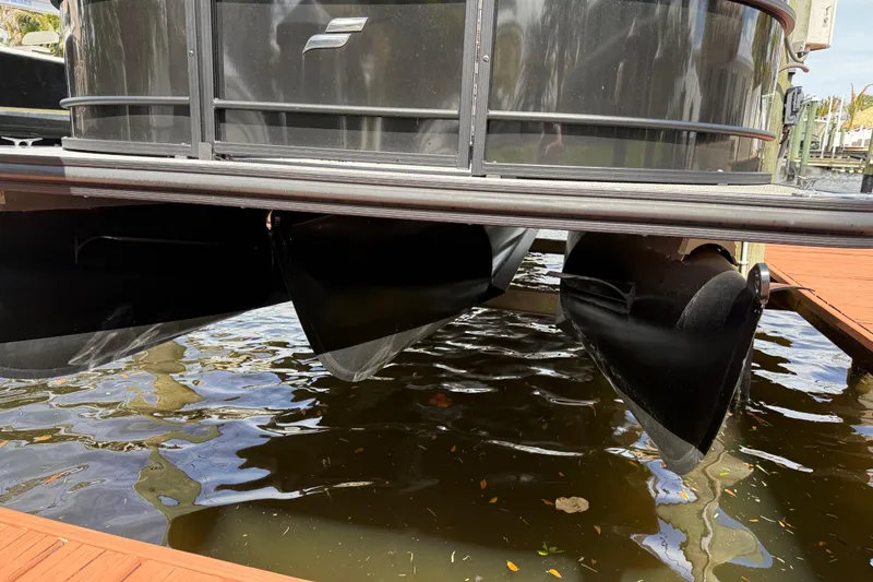 Slide: The Image of 2023 Starcraft EXS 3 Q pontoon boat on water, showcasing sleek design and structure. - 13