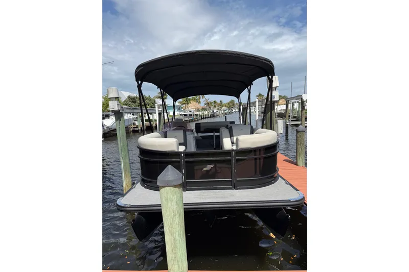 Slide: The Image of 2023 Starcraft EXS 3 Q pontoon boat docked on a sunny day. - 18