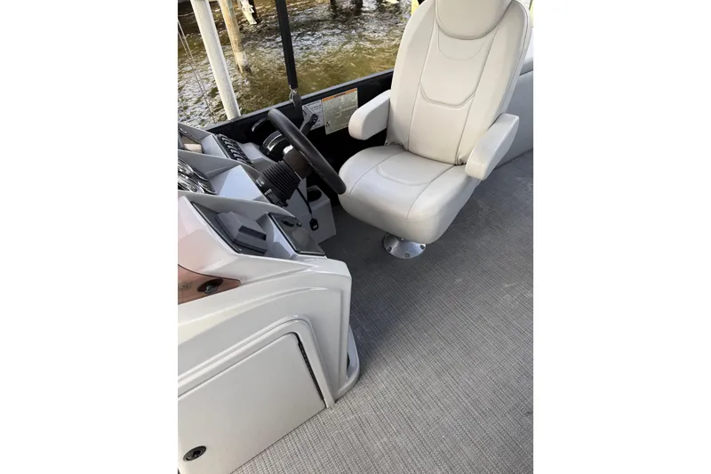 Slide: The Image of 2023 Starcraft EXS 3 Q boat interior with captain's chair and steering console. - 24
