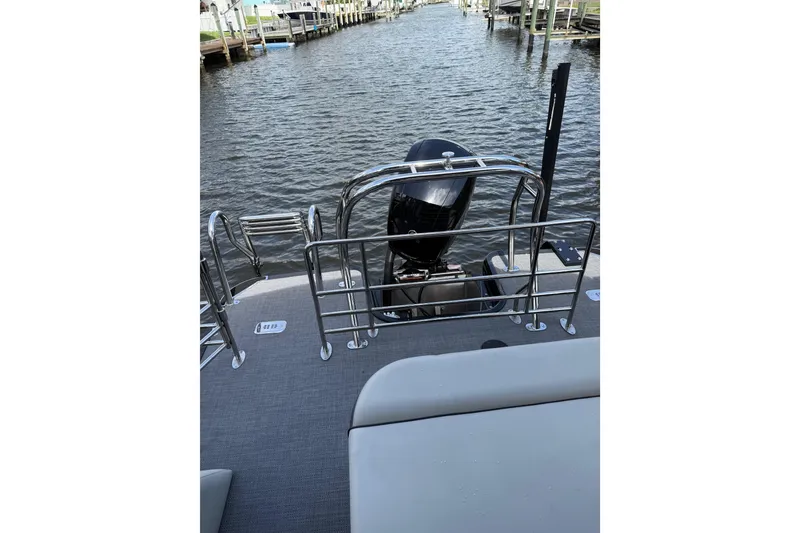 Slide: The Image of 2023 Starcraft EXS 3 Q boat with motor, docked on a calm waterway. - 26