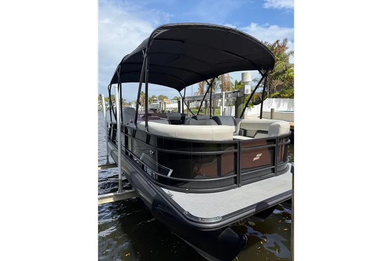 Slide: The Image of 2023 Starcraft EXS 3 Q pontoon boat docked on a sunny day. - 3