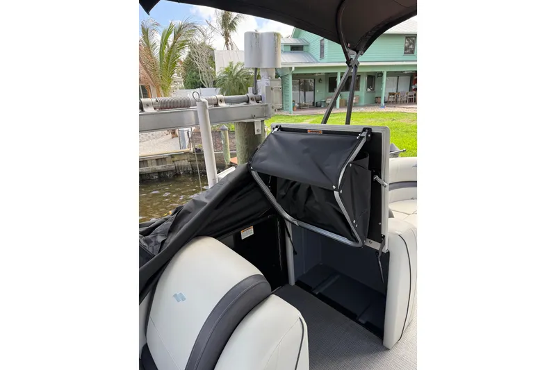 Slide: The Image of 2023 Starcraft EXS 3 Q boat interior with seating and storage compartment. - 32