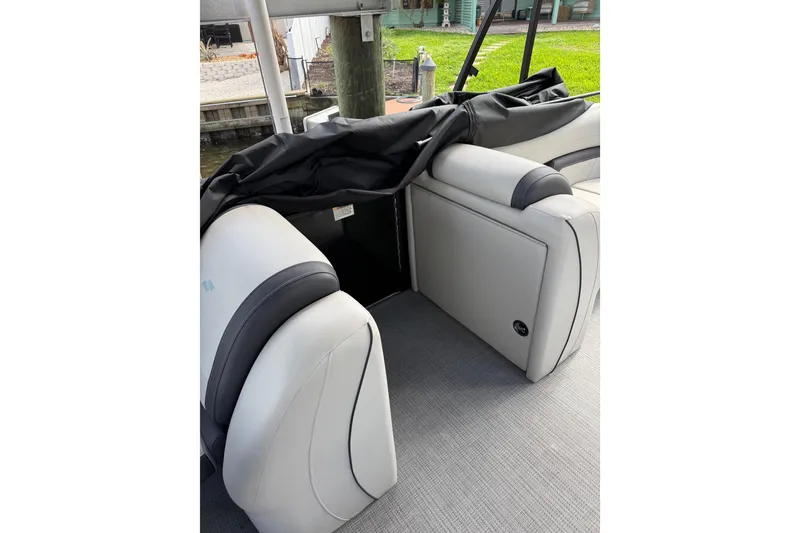 Slide: The Image of 2023 Starcraft EXS 3 Q boat interior with gray and black seating. - 33