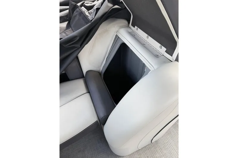 Slide: The Image of 2023 Starcraft EXS 3 Q boat interior storage compartment with cushioned seating. - 34