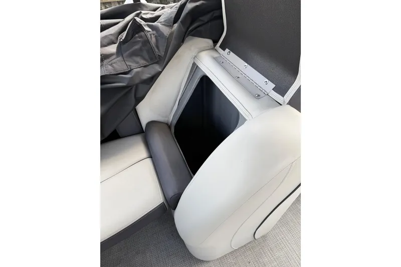Slide: The Image of 2023 Starcraft EXS 3 Q boat seat storage compartment with cover partially open. - 35