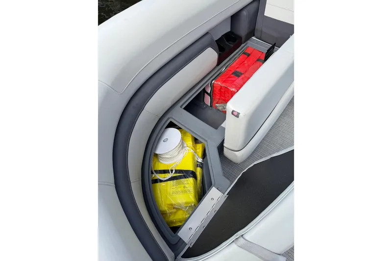Slide: The Image of 2023 Starcraft EXS 3 Q boat storage compartment with safety equipment and life jackets. - 39