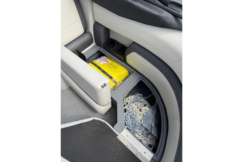 Slide: The Image of Storage compartment in 2023 Starcraft EXS 3 Q boat with ropes and supplies. - 41