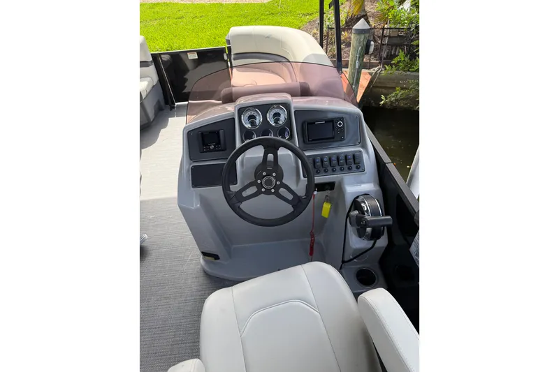 Slide: The Image of 2023 Starcraft EXS 3 Q boat dashboard with steering wheel and controls. - 42