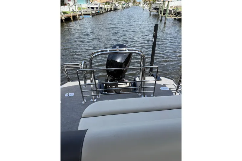 Slide: The Image of 2023 Starcraft EXS 3 Q boat on a canal, featuring a sleek outboard motor. - 46