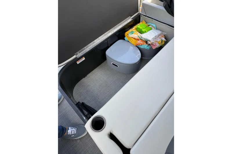 Slide: The Image of 2023 Starcraft EXS 3 Q boat interior storage with seat cushions and supplies. - 49
