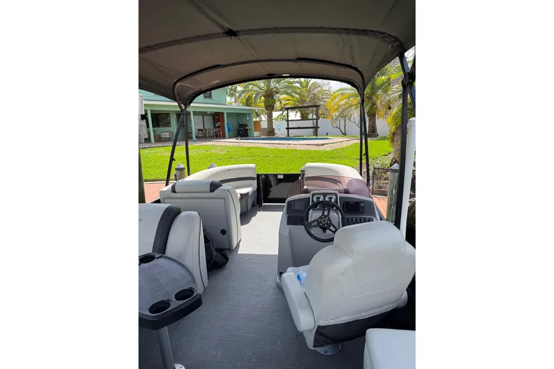 Slide: The Image of 2023 Starcraft EXS 3 Q pontoon boat interior with helm and seating. - 5