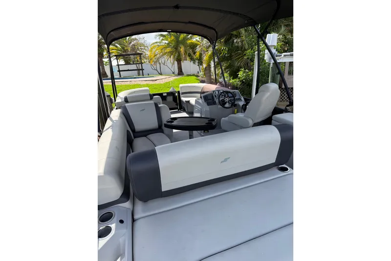 Slide: The Image of 2023 Starcraft EXS 3 Q pontoon boat interior with seating and steering console. - 8