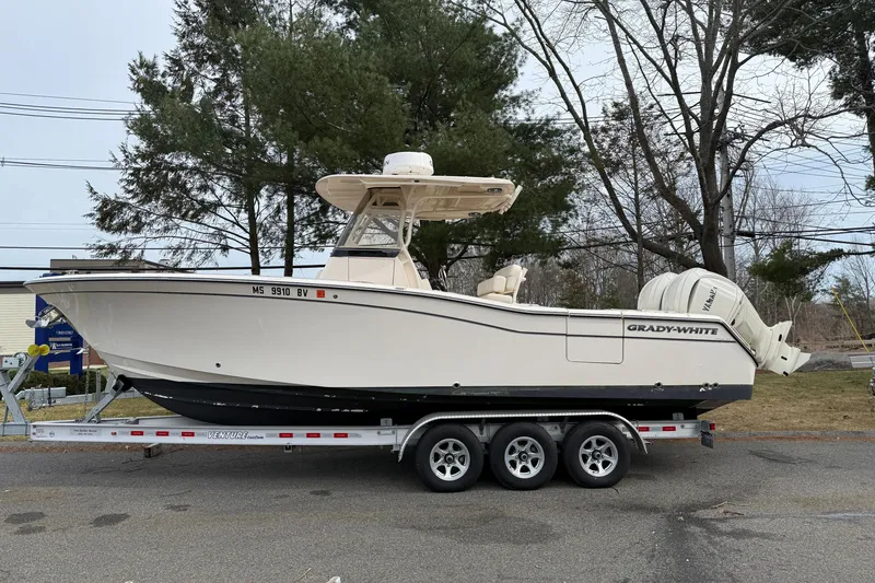 Slide: The Image of 2024 Grady-White Canyon 271 boat on trailer, parked outdoors. - 1