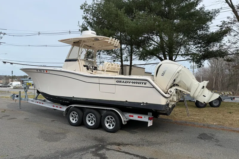 Slide: The Image of 2024 Grady-White Canyon 271 boat on trailer, parked outdoors. - 2