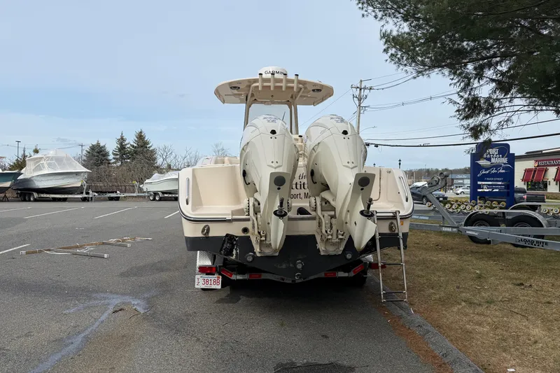 Slide: The Image of 2024 Grady-White Canyon 271 boat with dual engines in a parking lot. - 3
