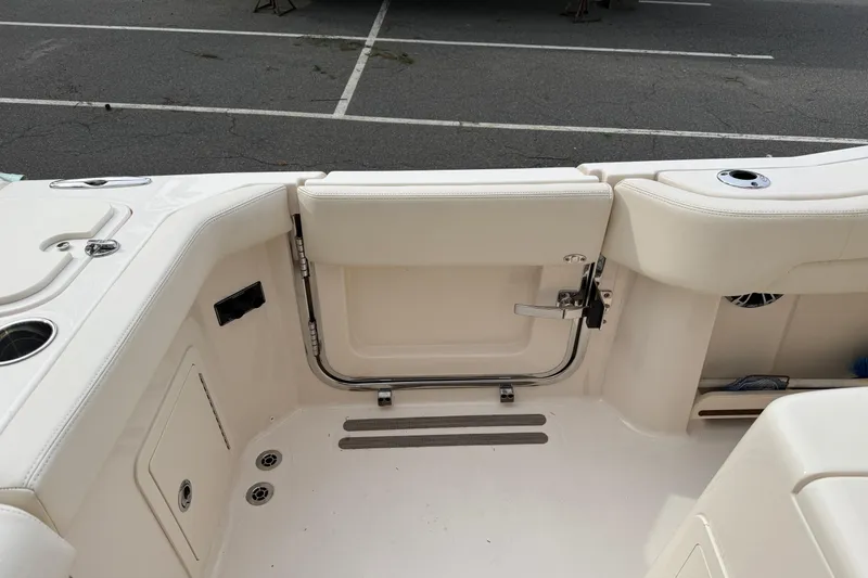 Slide: The Image of 2024 Grady-White Canyon 271 boat interior, featuring sleek seating and storage compartments. - 8