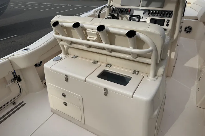 Slide: The Image of 2024 Grady-White Canyon 271 boat interior with rod holders and control panel. - 9