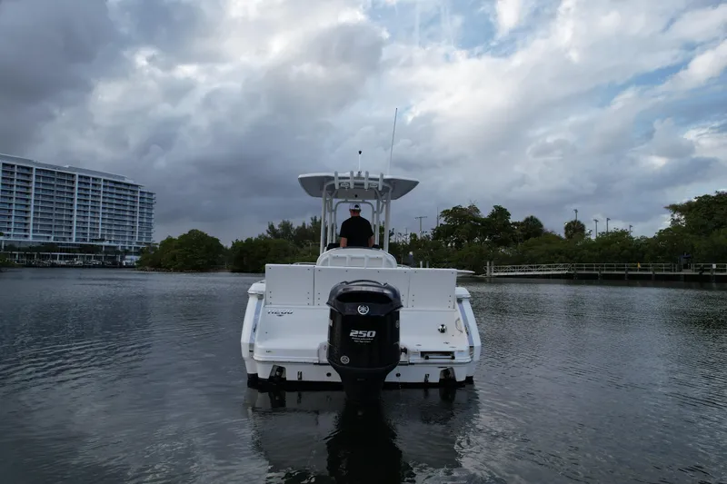 Slide: The Image of 2021 Robalo R230 Center Console boat on calm water under cloudy sky. - 12