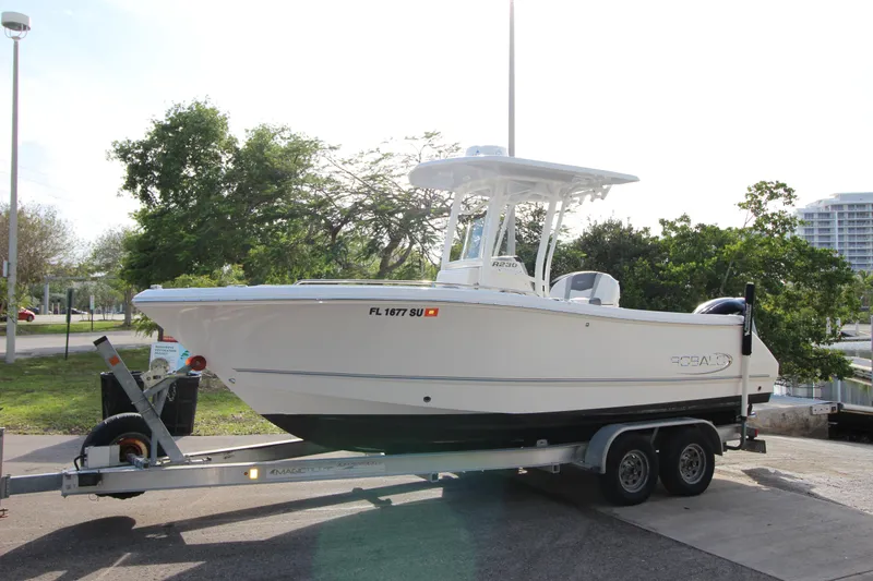 Slide: The Image of 2021 Robalo R230 Center Console boat on trailer, parked outdoors. - 18