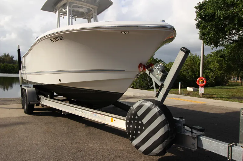Slide: The Image of 2021 Robalo R230 Center Console boat on trailer at a lakeside launch. - 19