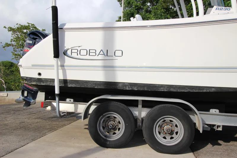 Slide: The Image of 2021 Robalo R230 Center Console boat on trailer, side view. - 20