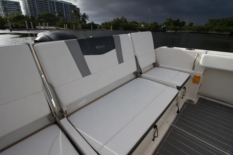 Slide: The Image of 2021 Robalo R230 Center Console boat interior with cushioned seating and sleek design. - 24