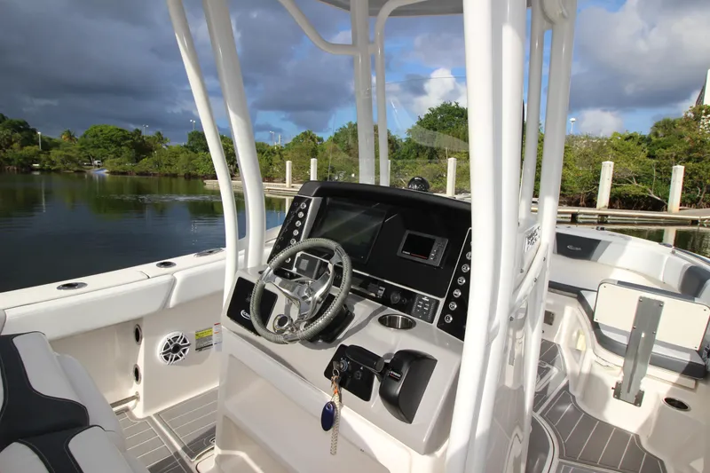 Slide: The Image of 2021 Robalo R230 Center Console boat interior with steering wheel and control panel. - 29