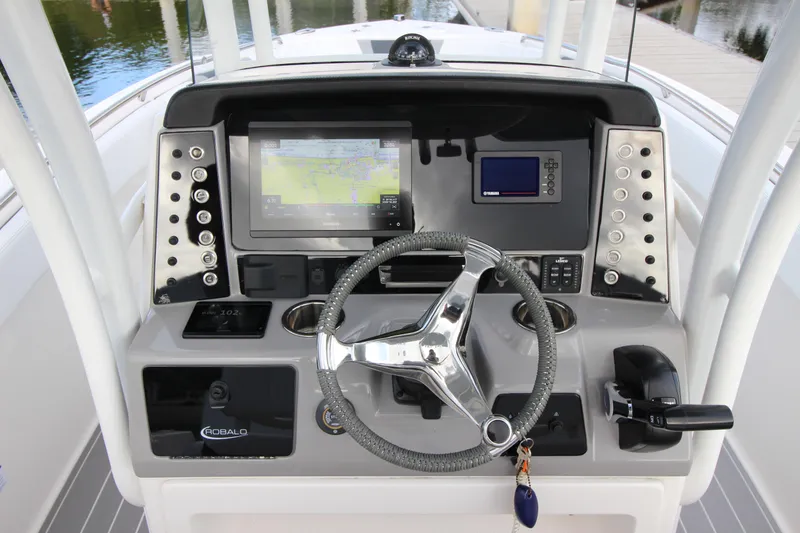 Slide: The Image of 2021 Robalo R230 Center Console dashboard with steering wheel and navigation displays. - 31