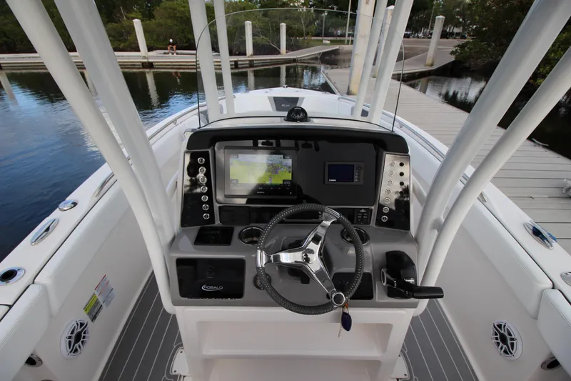 Slide: The Image of 2021 Robalo R230 Center Console boat dashboard with navigation system and steering wheel. - 32