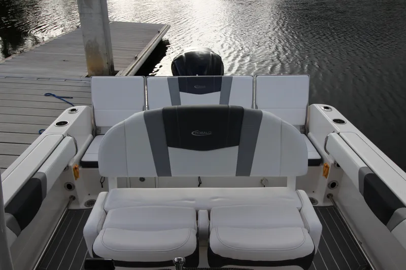 Slide: The Image of 2021 Robalo R230 Center Console boat interior with cushioned seating at dock. - 38