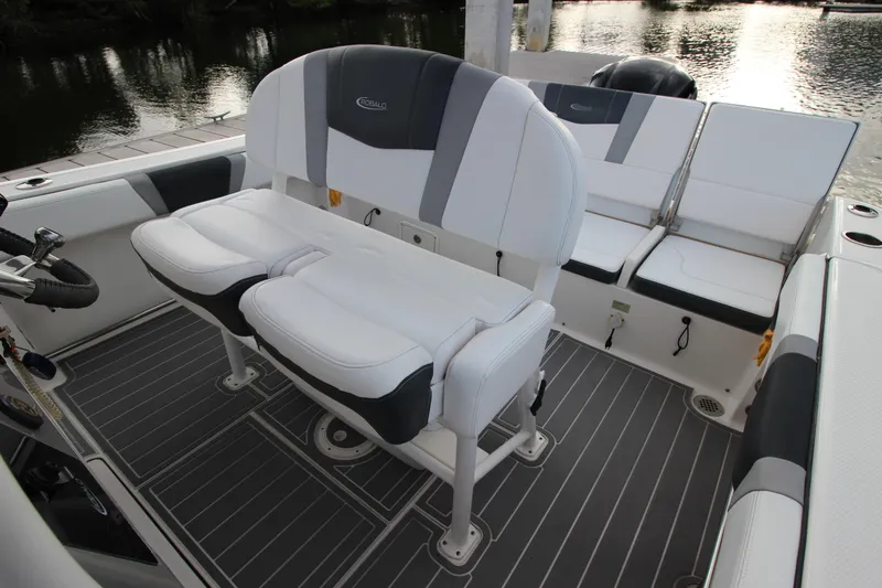 Slide: The Image of 2021 Robalo R230 Center Console boat interior with white seating and gray flooring. - 39