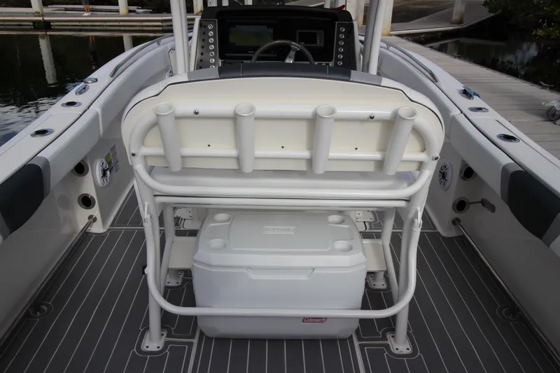 Slide: The Image of 2021 Robalo R230 Center Console boat interior with rod holders and cooler. - 40