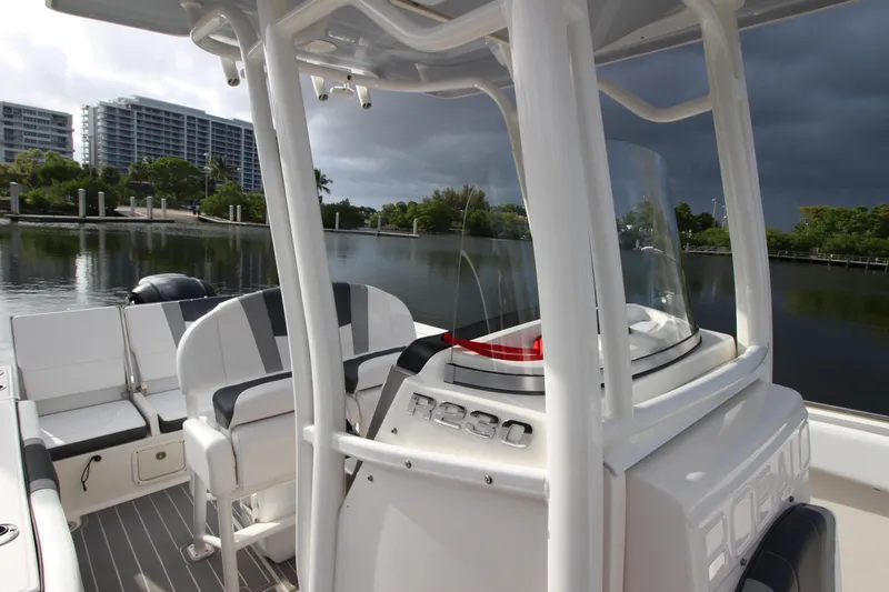 Slide: The Image of 2021 Robalo R230 Center Console boat docked near waterfront with modern seating. - 41