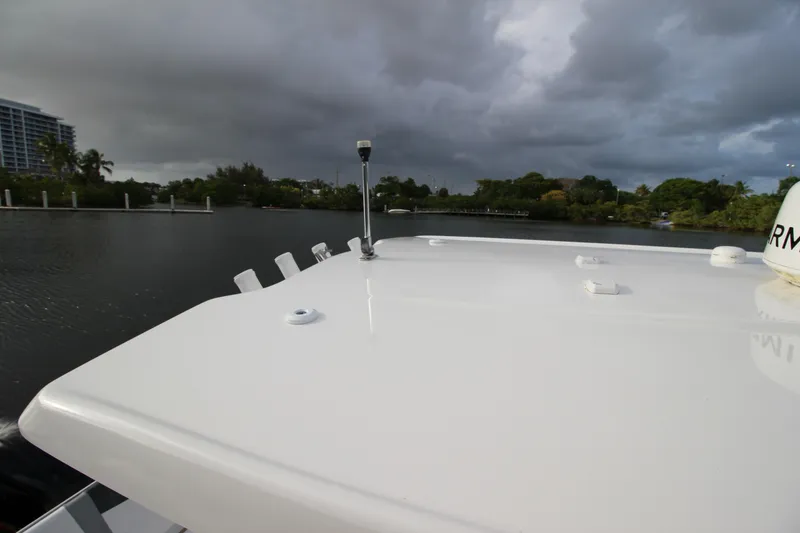 Slide: The Image of 2021 Robalo R230 Center Console boat on calm water under cloudy sky. - 49