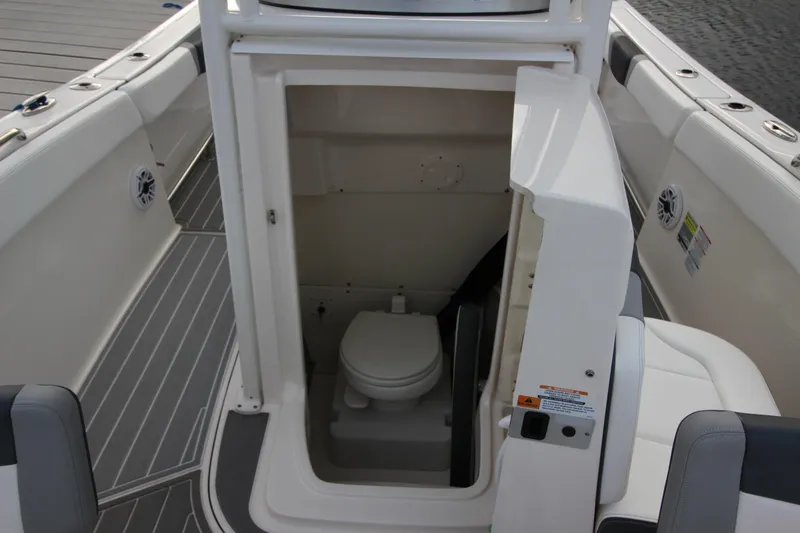 Slide: The Image of 2021 Robalo R230 Center Console boat with onboard toilet compartment. - 53