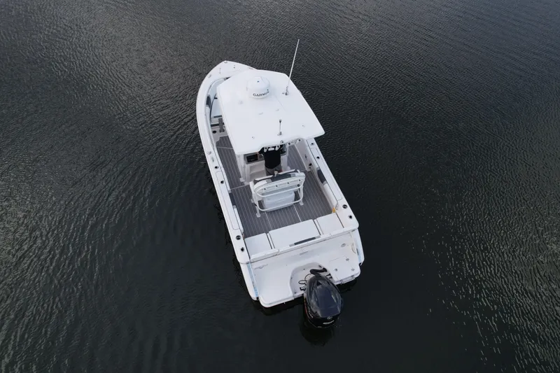 Slide: The Image of 2021 Robalo R230 Center Console boat on calm water, aerial view. - 6