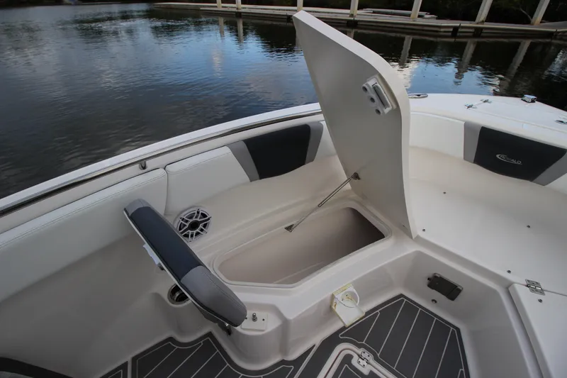 Slide: The Image of 2021 Robalo R230 Center Console boat with open storage compartment and seating. - 77