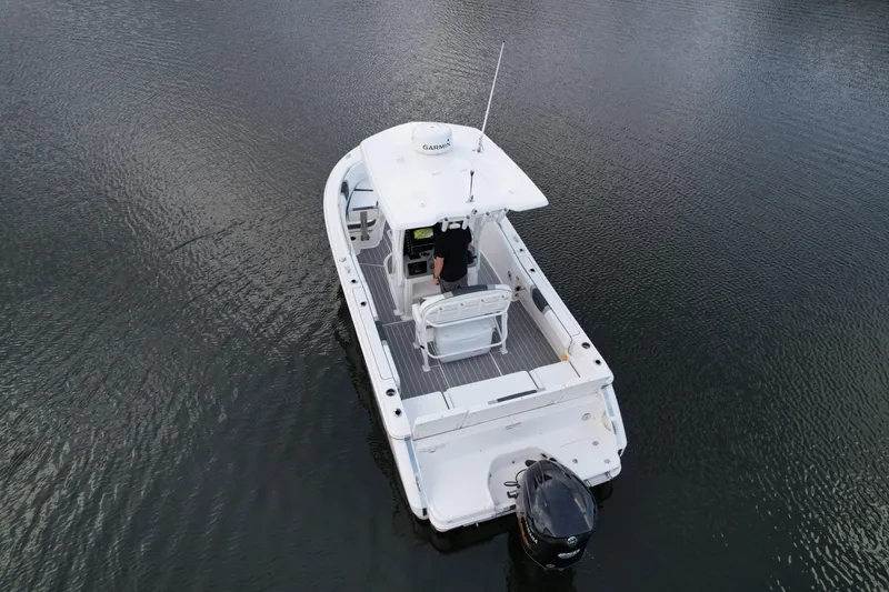 Slide: The Image of 2021 Robalo R230 Center Console boat on calm water, aerial view. - 8