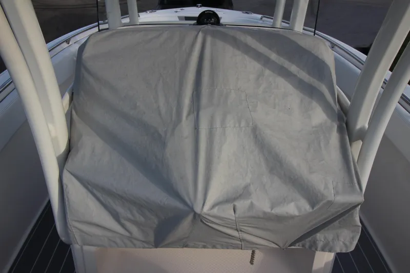 Slide: The Image of 2021 Robalo R230 Center Console with covered helm station, showcasing protective cover. - 80
