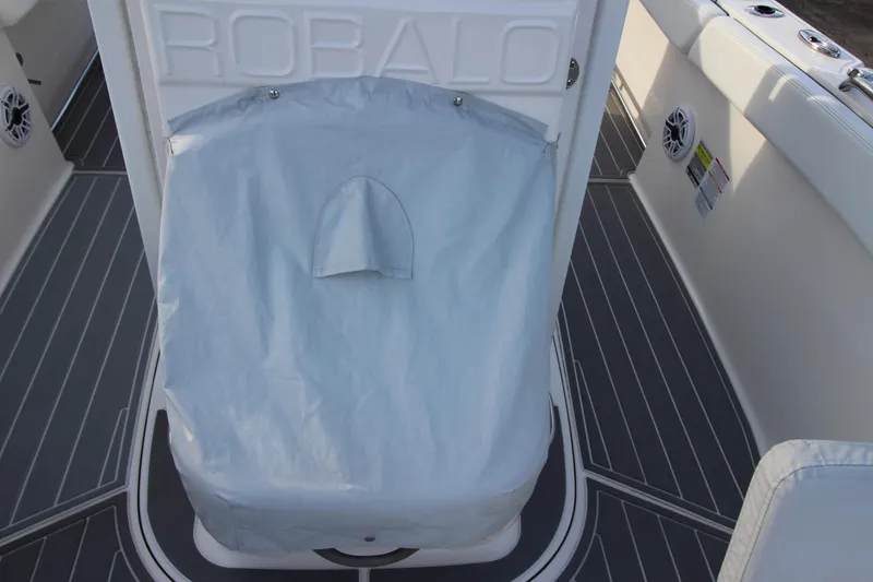 Slide: The Image of 2021 Robalo R230 Center Console boat interior with covered seat and sleek flooring. - 81