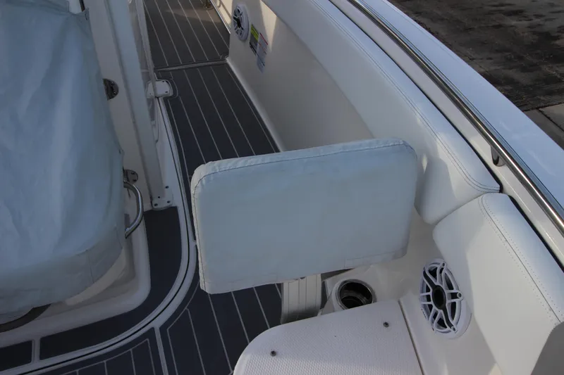 Slide: The Image of 2021 Robalo R230 Center Console boat interior with cushioned seating and speaker. - 82