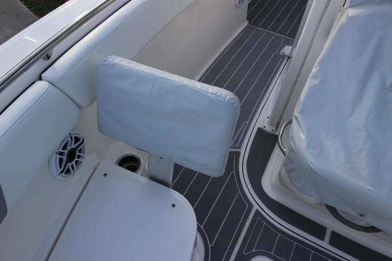 Slide: The Image of Interior view of 2021 Robalo R230 Center Console boat with seating and speaker. - 83