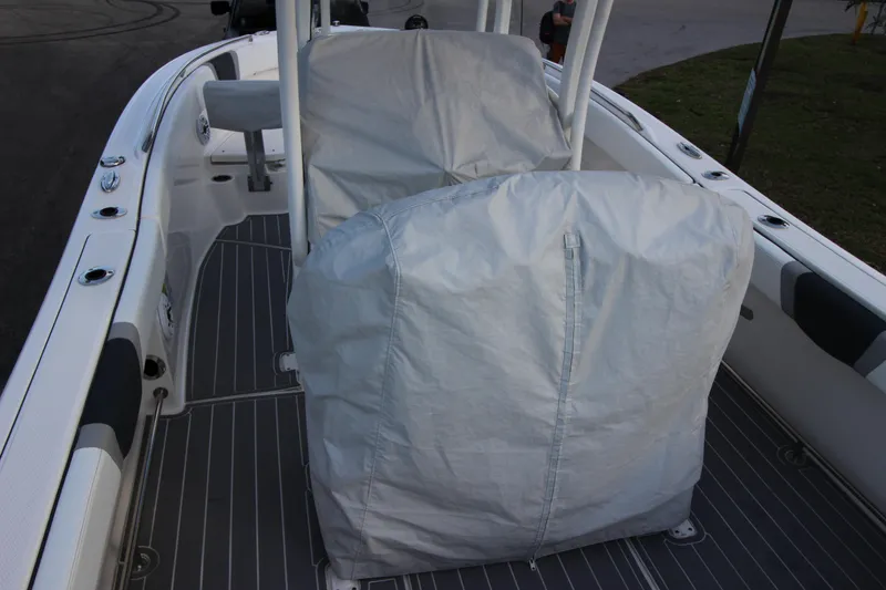 Slide: The Image of 2021 Robalo R230 Center Console boat interior with covered seating. - 87