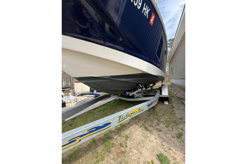Slide: The Image of 2016 Chaparral 224 Sunesta boat on trailer, parked beside a building. - 13