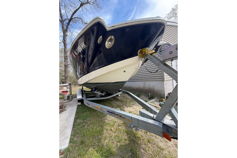 Slide: The Image of 2016 Chaparral 224 Sunesta boat on trailer, parked beside a house. - 14