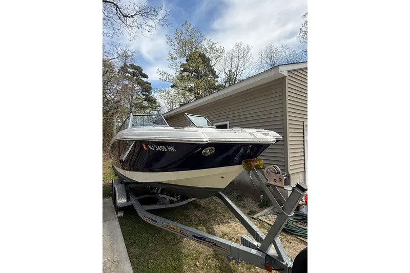 Slide: The Image of 2016 Chaparral 224 Sunesta boat on trailer beside a house. - 17
