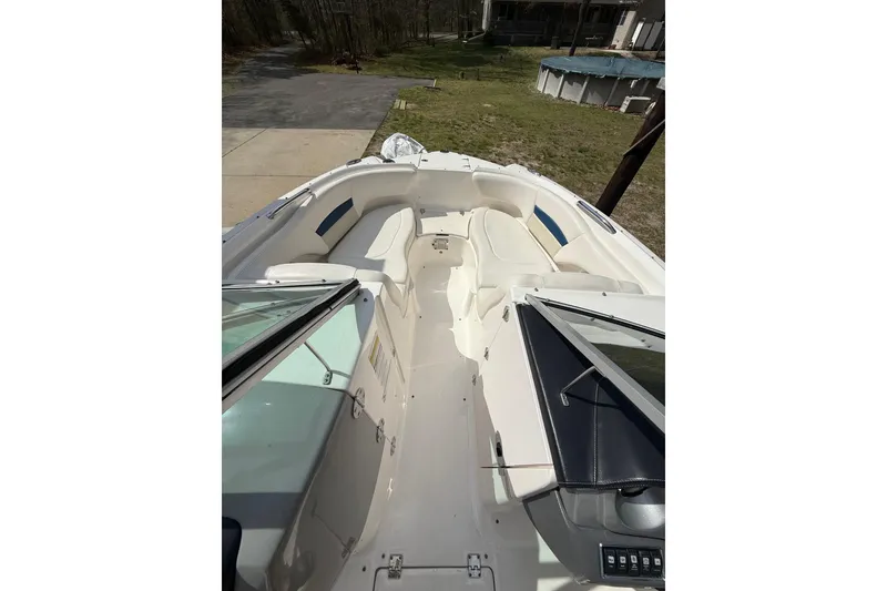 Slide: The Image of 2016 Chaparral 224 Sunesta boat interior with white seating and open deck view. - 20