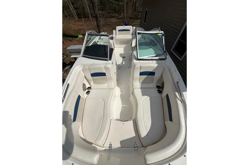 Slide: The Image of 2016 Chaparral 224 Sunesta boat interior with white seating and open windshield. - 23